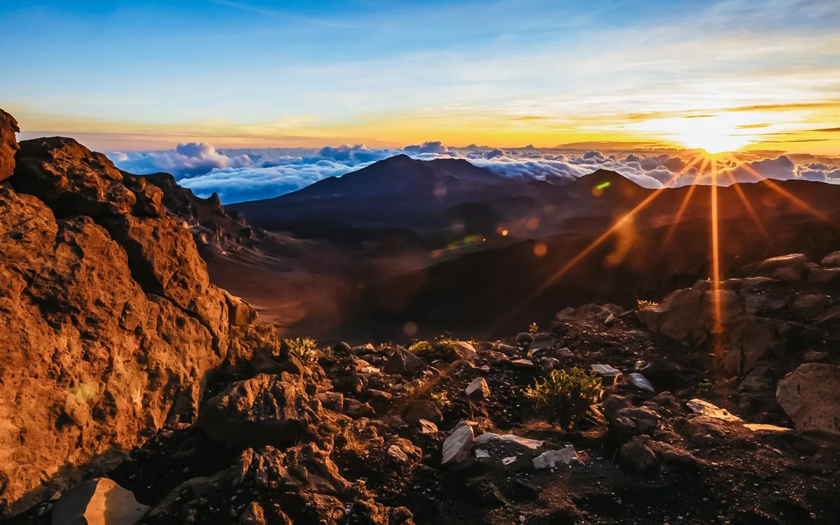 People gathered on the crater rim of Haleakalā as the sun comes up