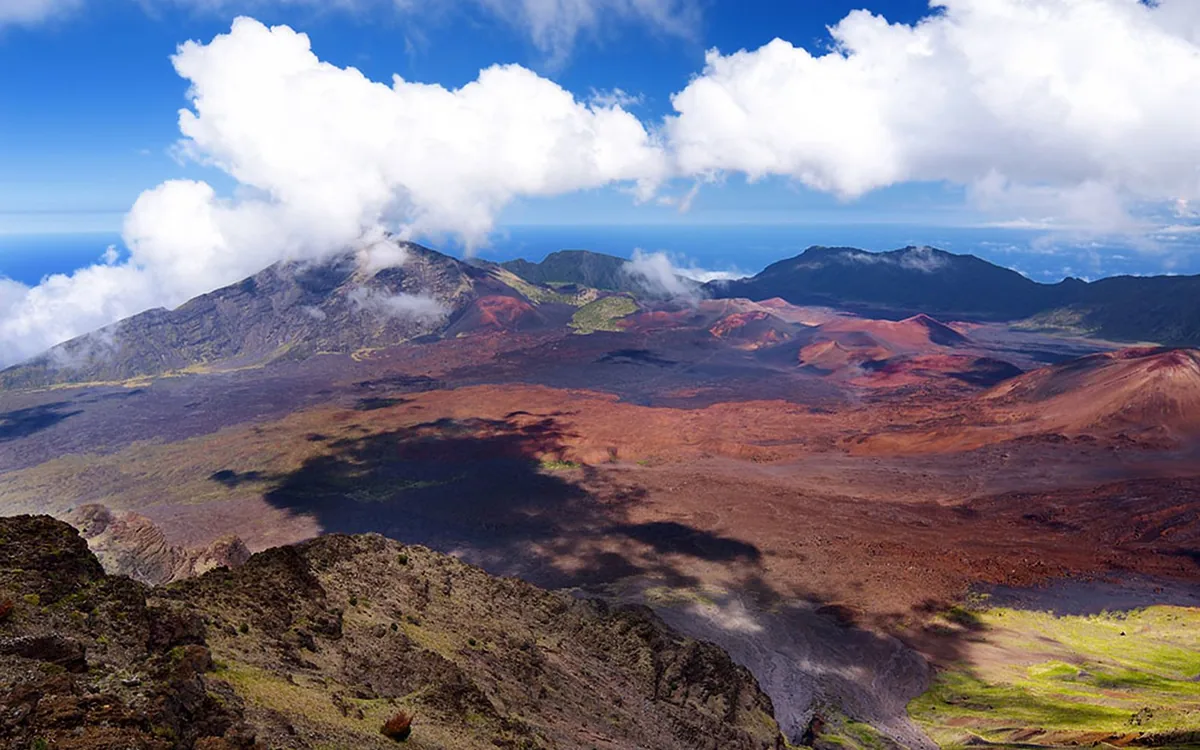 The broad shield profile of Haleakala rising above the fields of Upcountry Maui